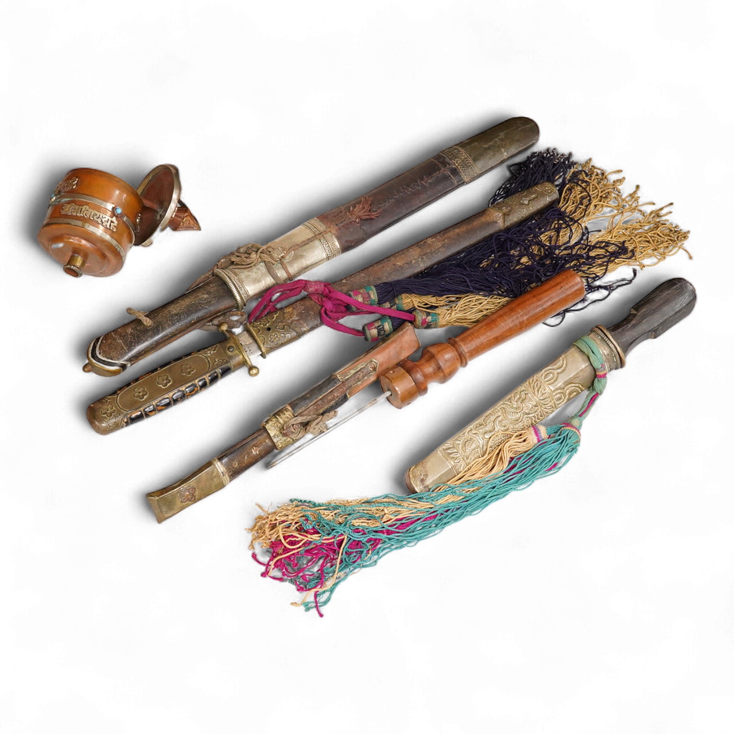 Four Tibetan daggers, early 20th century and a prayer wheel